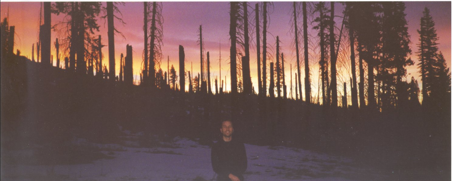 Francis Tapon posing in front of an amazing sunrise in a burned out forest Yosemite over Thanksgiving 2000. 