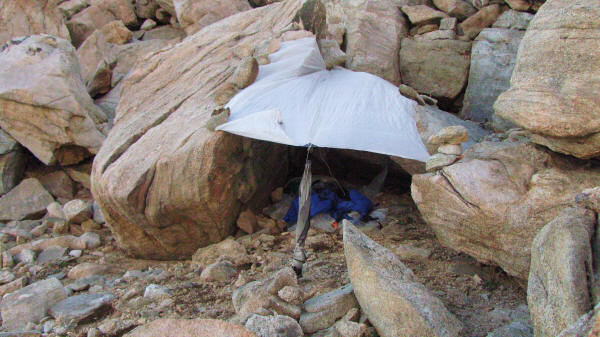 Without trekking poles, I used rocks to hold down my tarp. I didn't expect rain that night, but the tarp trapped a bit of heat. The rocks around me sheltered me from the cold wind.