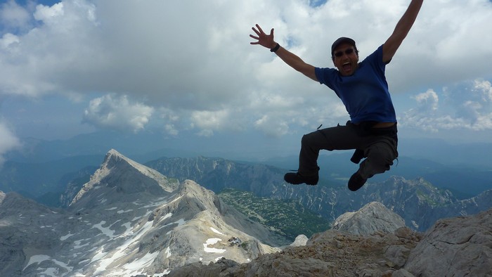 Francis Tapon jumping for joy on top of Mt. Triglav in Slovenia